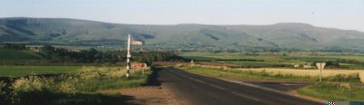 Photograph: Looking east toward the Pennine Mountains along the A686 road to Melmerby from Langwathby village, 4 miles to the west.